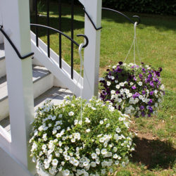 What D Hook Display Hook showcasing its hanging ability on porch posts.